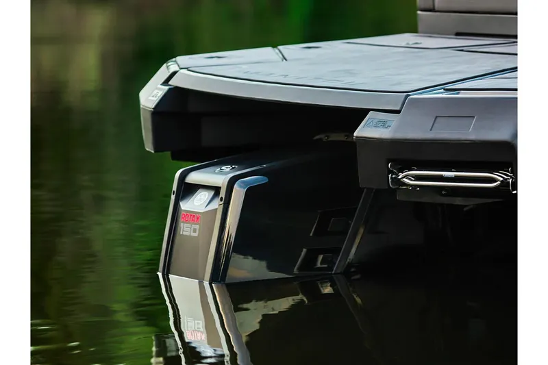 Slide: The Image of 2024 Manitou Explore 24 Navigator with Rotax 150 engine on calm water. - 16