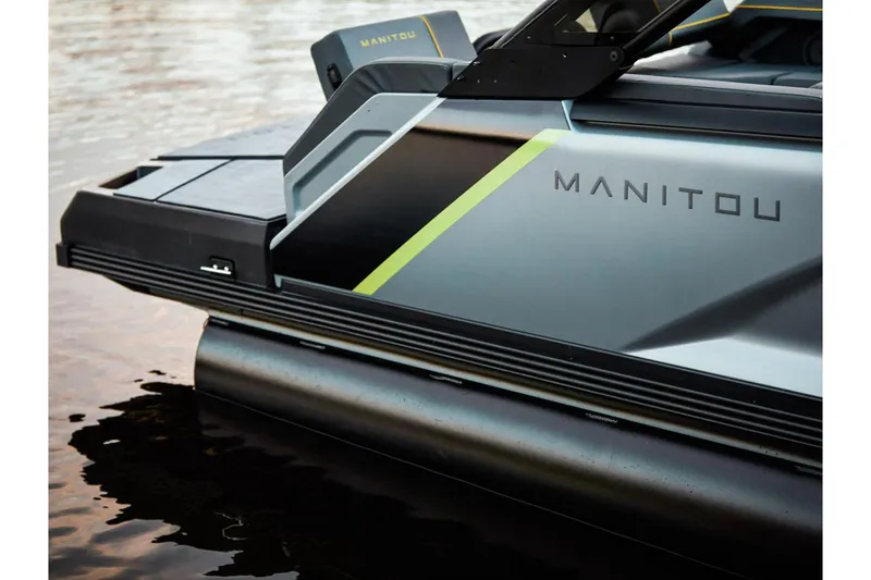 Slide: The Image of 2024 Manitou Explore 24 Navigator pontoon boat on water, sleek design. - 17