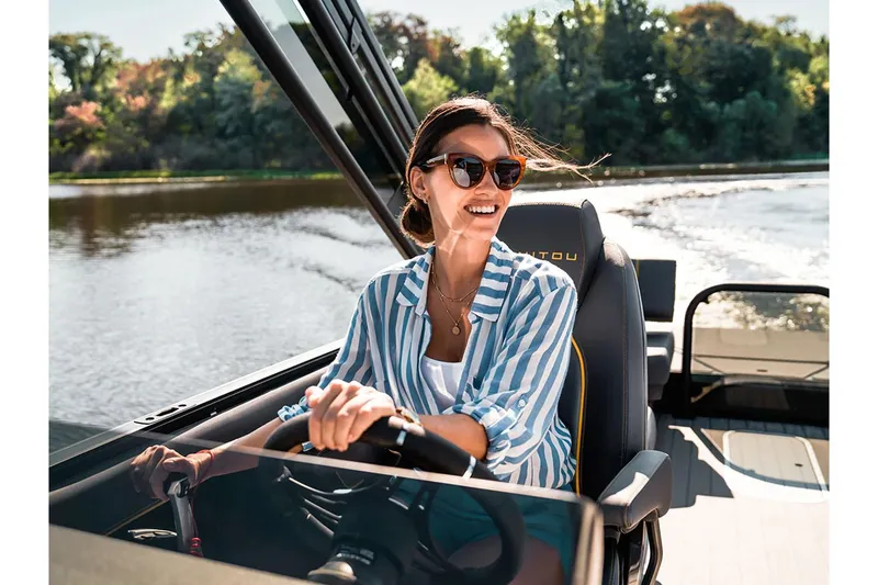 Slide: The Image of Woman enjoying a ride on a 2024 Manitou Explore 24 Navigator boat. - 18