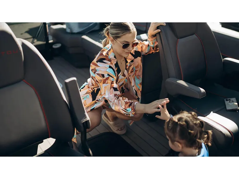 Slide: The Image of Woman and child on 2024 Manitou Explore 24 Navigator boat, enjoying a sunny day. - 23