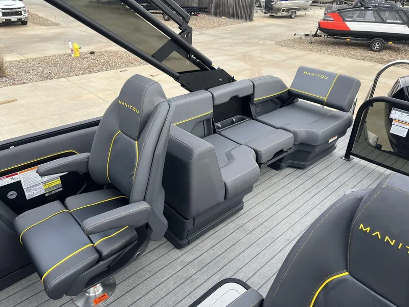 Slide: The Image of 2024 Manitou Explore 24 Navigator boat interior with gray and yellow seating. - 7