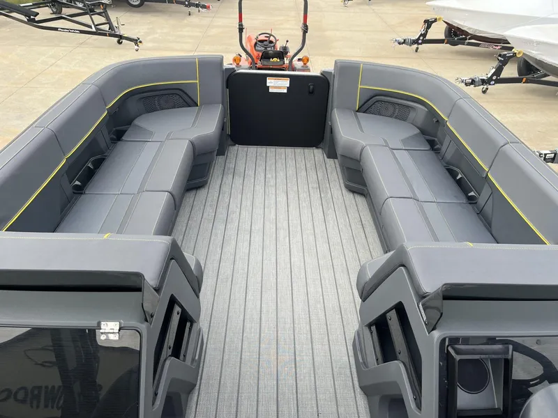 Slide: The Image of 2024 Manitou Explore 24 Navigator boat interior with spacious seating and modern design. - 9