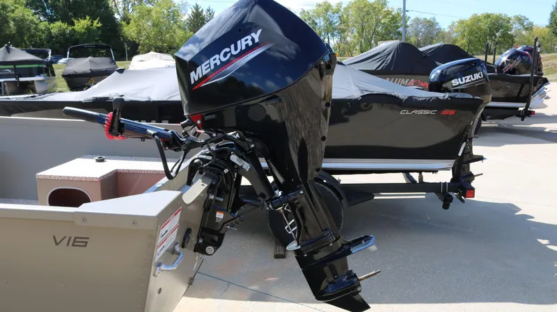 Slide: The Image of 2024 Alumacraft V-16 Tiller boat with Mercury outboard motor in a showroom. - 3