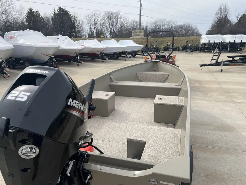 Slide: The Image of 2024 Alumacraft V-16 Tiller boat with Mercury 25 engine in outdoor showroom. - 5