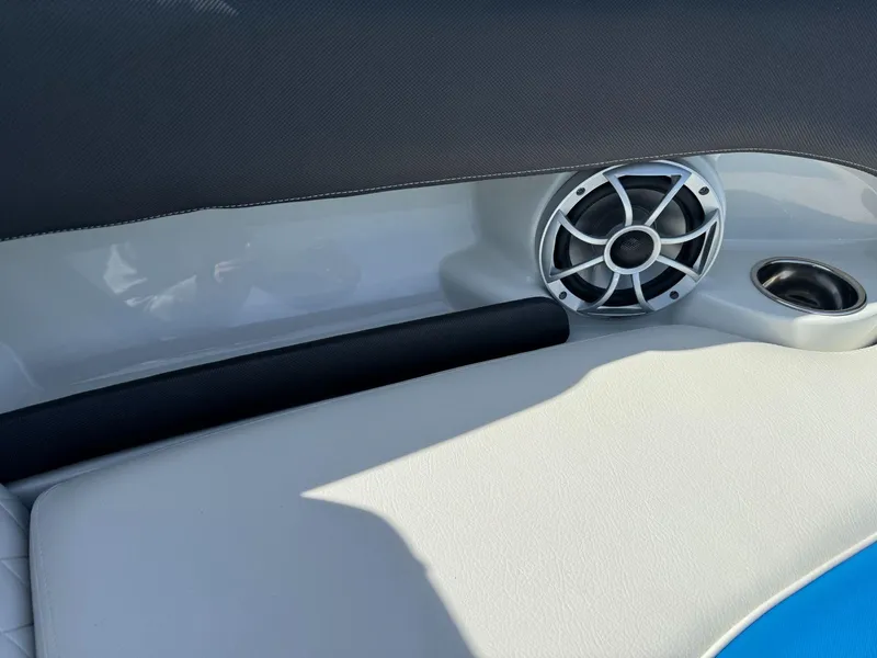 Slide: The Image of 2024 Crownline 220SS boat interior with speaker and cup holder. - 13