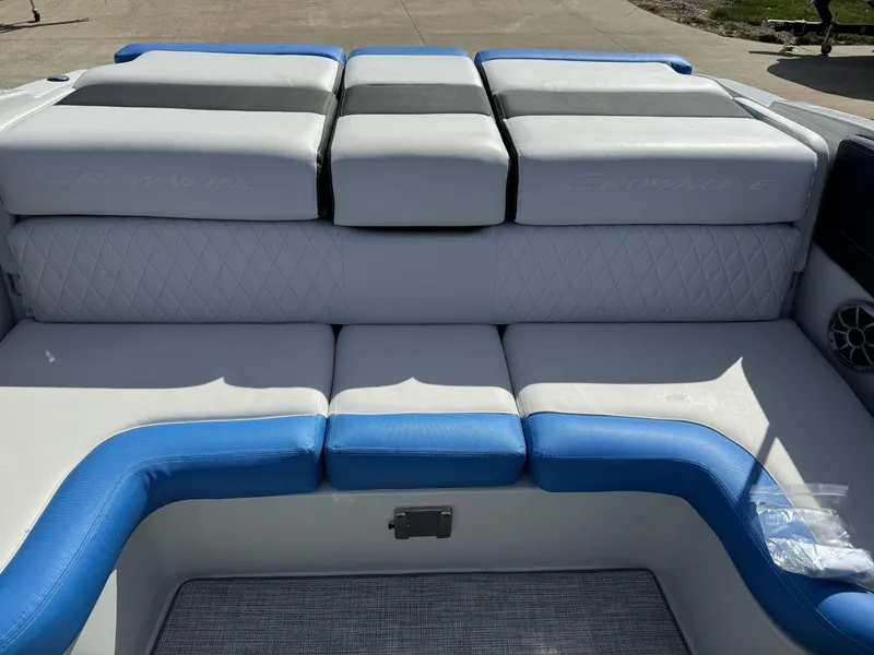 Slide: The Image of 2024 Crownline 220SS boat interior with blue and white seating. - 7