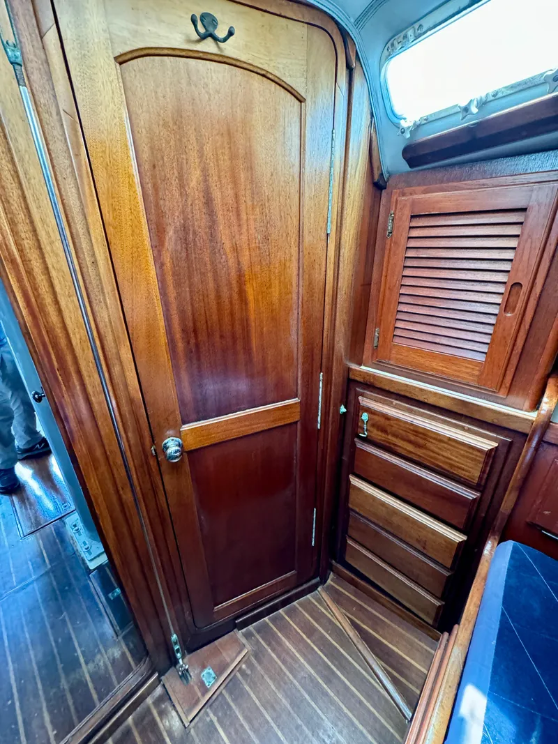 Slide: The Image of Interior of 1979 Islander IP Peterson 40 sailboat with wooden cabinetry and flooring. - 10
