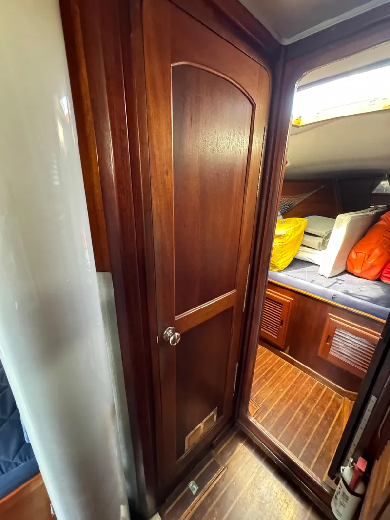 Slide: The Image of Interior of 1979 Islander IP Peterson 40 sailboat with wooden door and cozy cabin. - 14