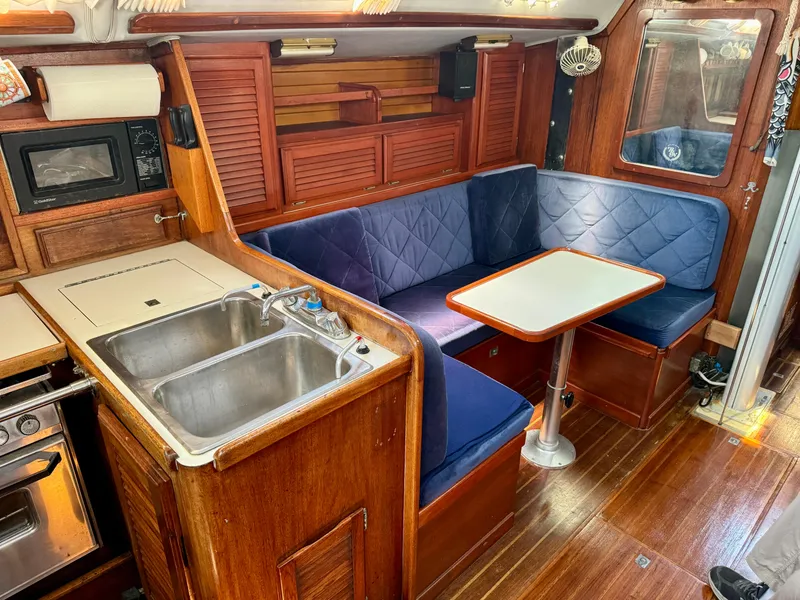Slide: The Image of Interior of 1979 Islander IP Peterson 40 sailboat with kitchen and dining area. - 19