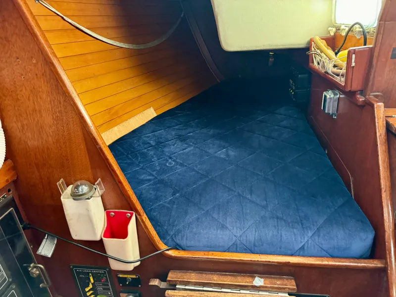 Slide: The Image of Cozy cabin interior of 1979 Islander IP Peterson 40 sailboat with blue bedding. - 20