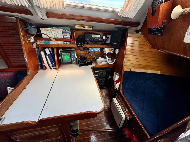 Slide: The Image of Navigation station inside 1979 Islander IP Peterson 40 sailboat with equipment and cozy cabin. - 28