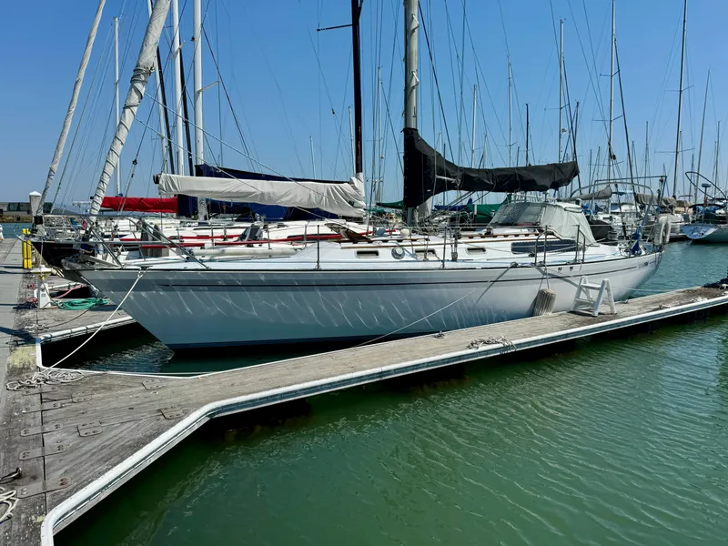 Slide: The Image of 1979 Islander IP Peterson 40 sailboat docked at marina, clear blue sky. - 3