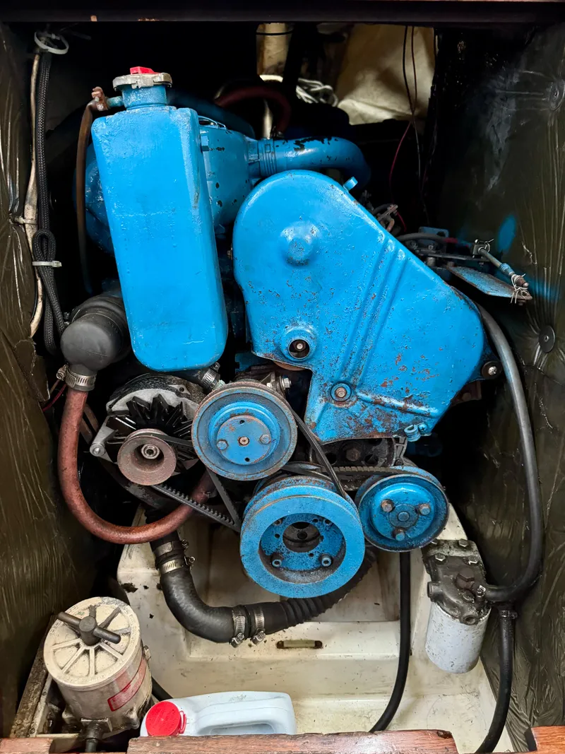 Slide: The Image of 1979 Islander IP Peterson 40 engine, blue, with visible belts and hoses in a compact compartment. - 30