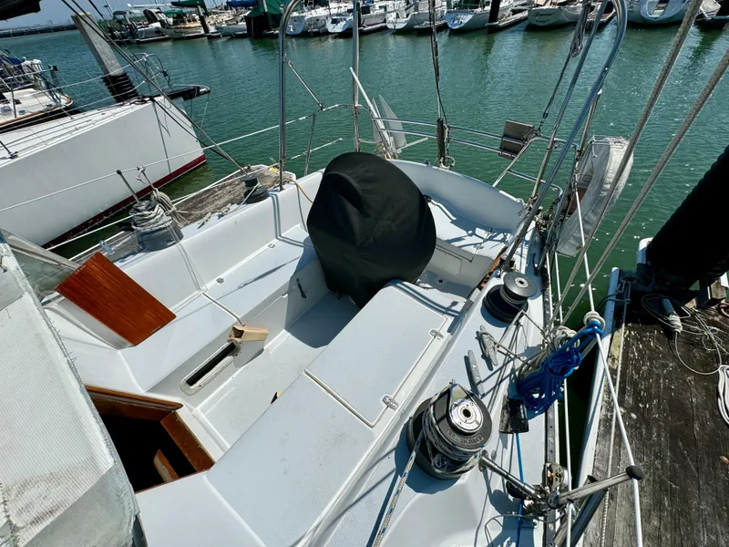 Slide: The Image of 1979 Islander IP Peterson 40 sailboat docked at marina, showing cockpit and deck details. - 38