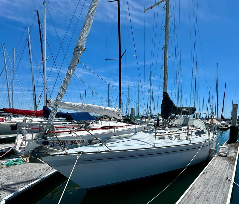 Slide: The Image of 1979 Islander IP Peterson 40 sailboat docked at marina under clear blue sky. - 5