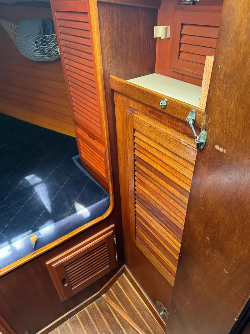 Slide: The Image of 1979 Islander IP Peterson 40 interior with wooden cabinetry and cushioned seating. - 9