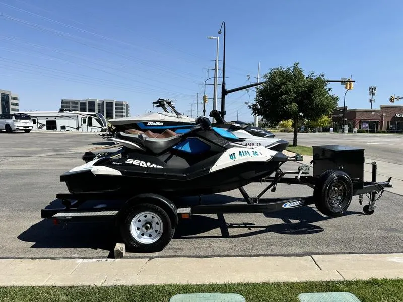 Slide: The Image of 2019 Sea-Doo GTX 300 and Spark 2UP on trailer in parking lot. - 3