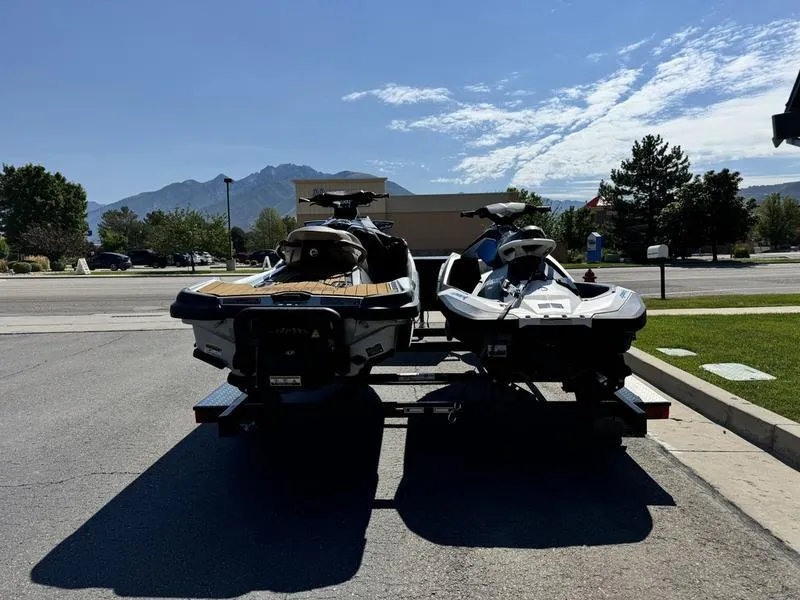 Slide: The Image of 2019 Sea-Doo GTX 300 and Spark 2UP jet skis on a trailer, scenic mountain backdrop. - 4