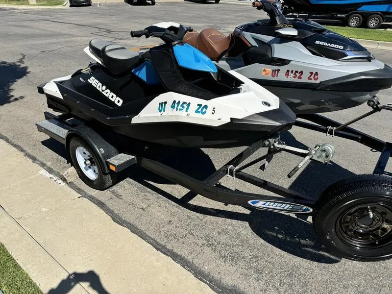Slide: The Image of 2019 Sea-Doo GTX 300 and Spark 2UP jet skis on trailer in parking lot. - 5