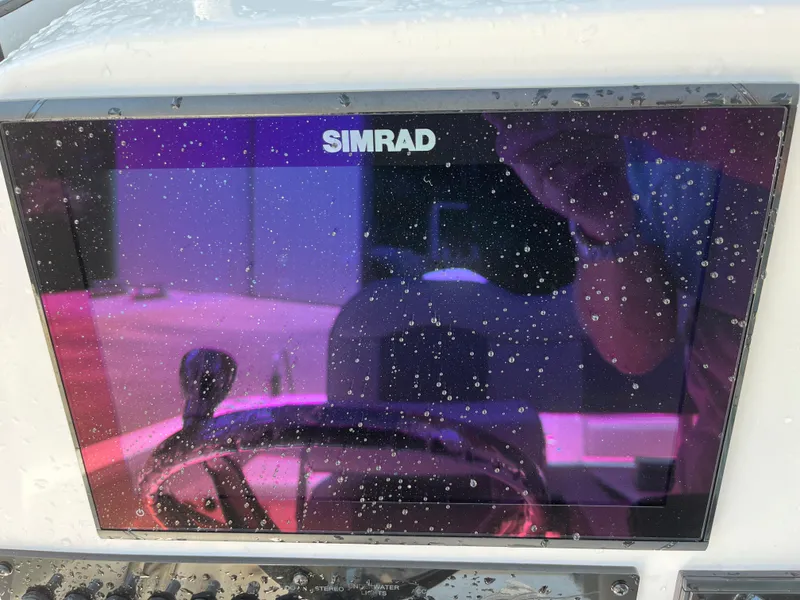 Slide: The Image of Simrad display on 2022 Aquasport 2300 Center Console, showing water droplets. - 11