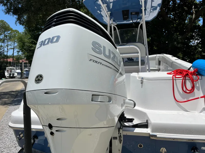 Slide: The Image of 2022 Aquasport 2300 Center Console with Suzuki 300 outboard motor, docked outdoors. - 14