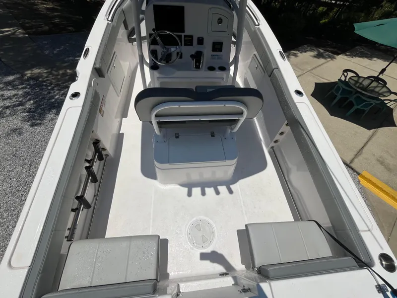 Slide: The Image of 2022 Aquasport 2300 Center Console boat interior with seating and steering console. - 16
