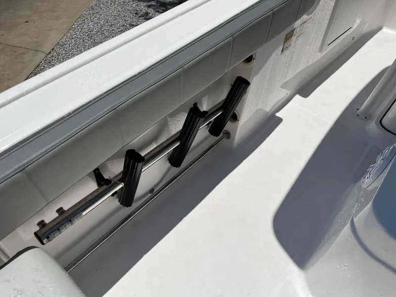 Slide: The Image of 2022 Aquasport 2300 Center Console boat interior with rod holders. - 17