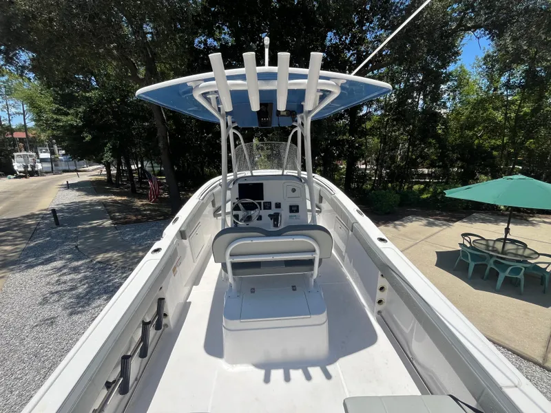 Slide: The Image of 2022 Aquasport 2300 Center Console boat with T-top and seating, docked outdoors. - 18