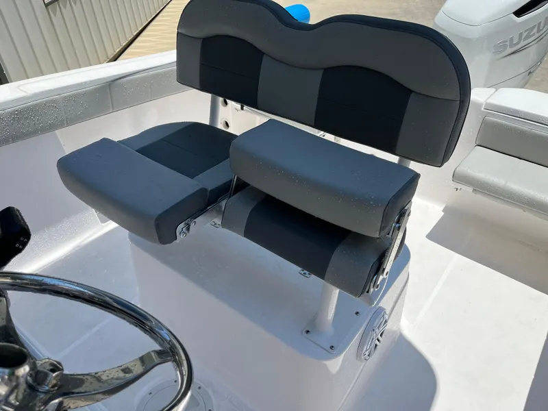 Slide: The Image of 2022 Aquasport 2300 Center Console boat seat and steering wheel detail. - 23