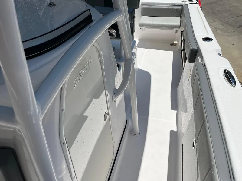 Slide: The Image of 2022 Aquasport 2300 Center Console boat interior, featuring sleek white deck and seating. - 24