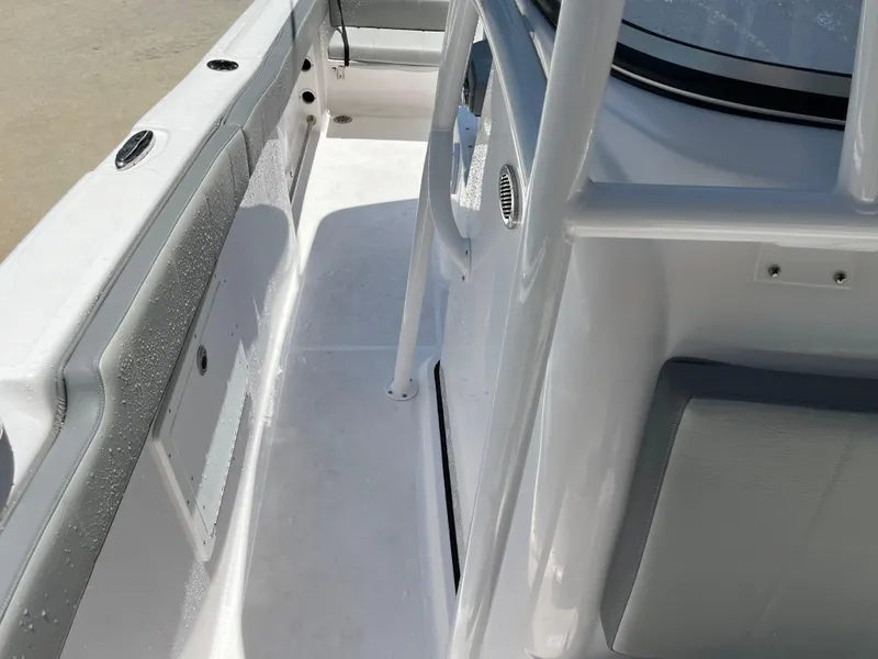 Slide: The Image of 2022 Aquasport 2300 Center Console boat interior, featuring sleek white design and spacious layout. - 25