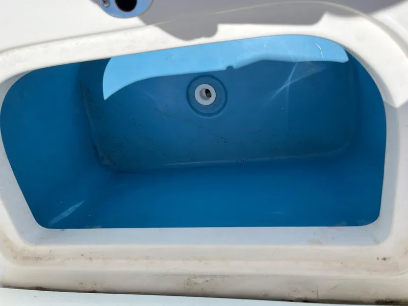 Slide: The Image of Livewell compartment of 2022 Aquasport 2300 Center Console boat. - 26