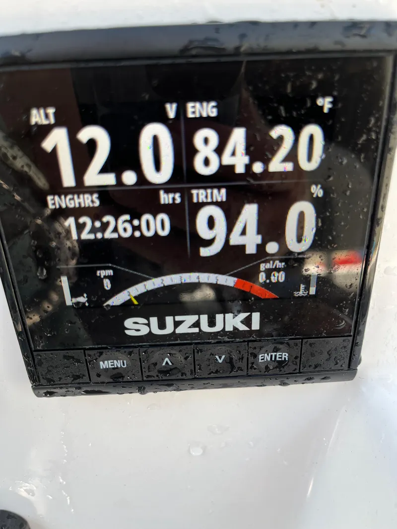 Slide: The Image of Suzuki engine display on 2022 Aquasport 2300 Center Console showing 12V, 84.2°F, 94% trim. - 31