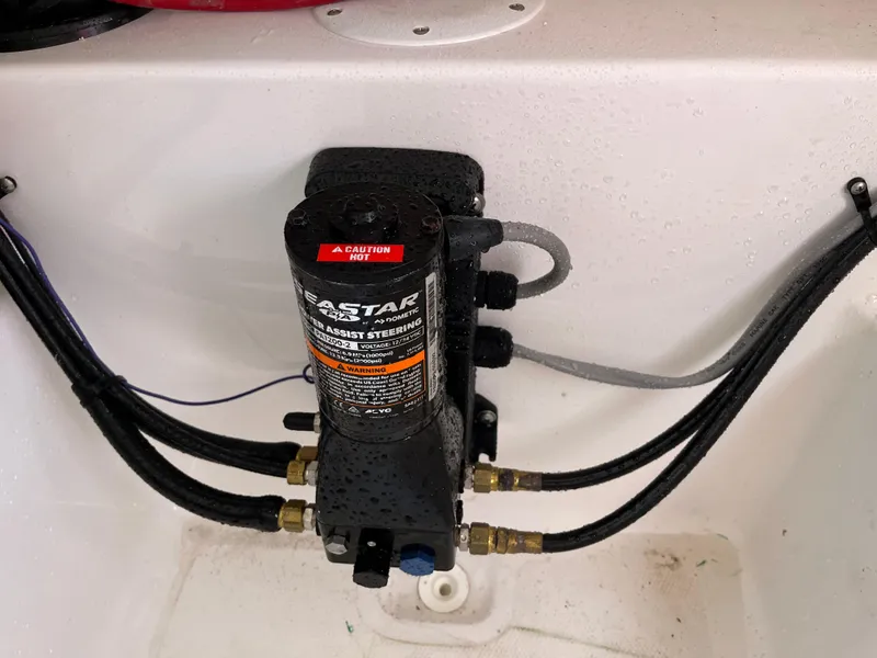 Slide: The Image of SeaStar hydraulic steering system in a 2022 Aquasport 2300 Center Console boat. - 35