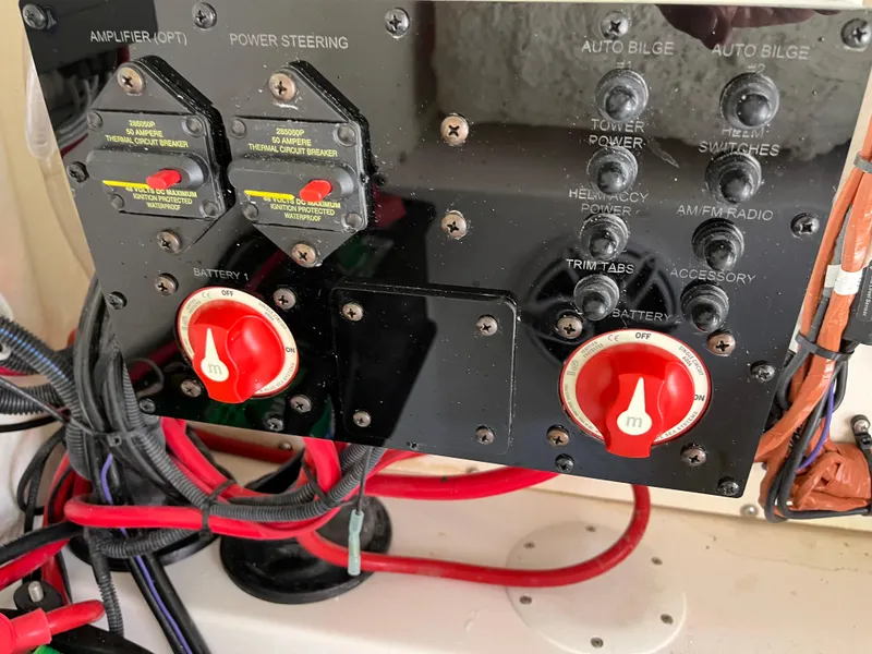 Slide: The Image of Control panel of a 2022 Aquasport 2300 Center Console boat with switches and wiring. - 36