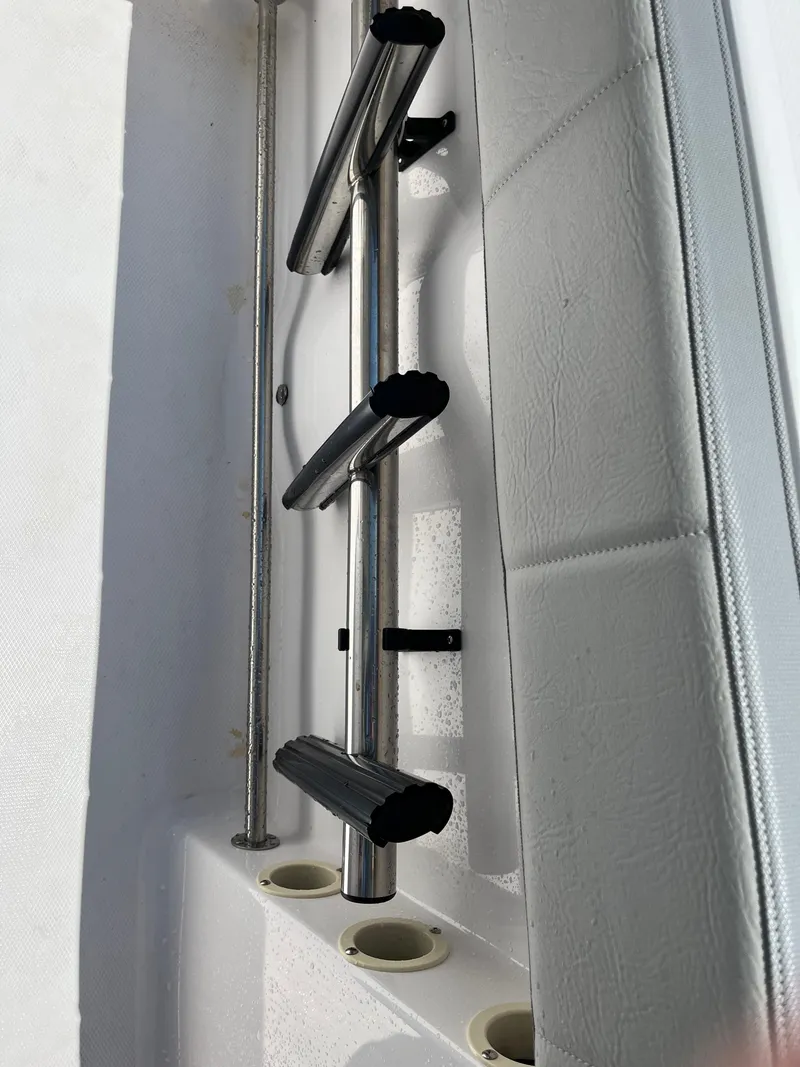 Slide: The Image of 2022 Aquasport 2300 Center Console rod holders and storage detail. - 6