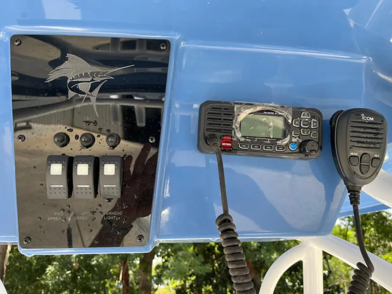 Slide: The Image of 2022 Aquasport 2300 Center Console dashboard with controls and radio equipment. - 9