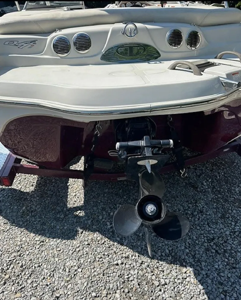 Slide: The Image of 2014 Tahoe Q4i boat rear view with propeller on gravel surface. - 4