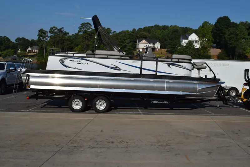 The Image of 2025 Angler Qwest 8524 ALL SPORT pontoon boat on trailer in parking lot. - 1