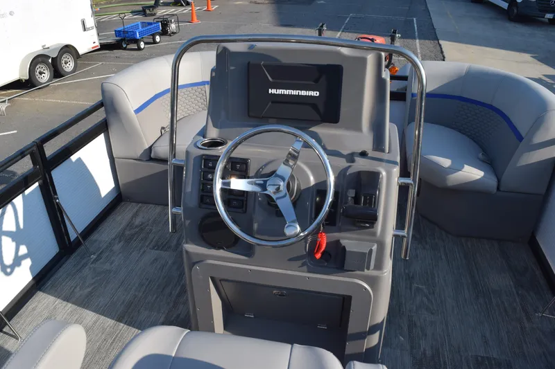 Slide: The Image of 2025 Angler Qwest 8524 ALL SPORT boat interior with steering console and seating. - 17