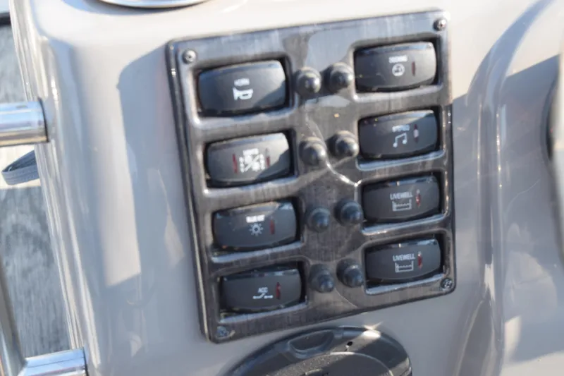 Slide: The Image of Control panel of 2025 Angler Qwest 8524 ALL SPORT boat with labeled switches. - 19