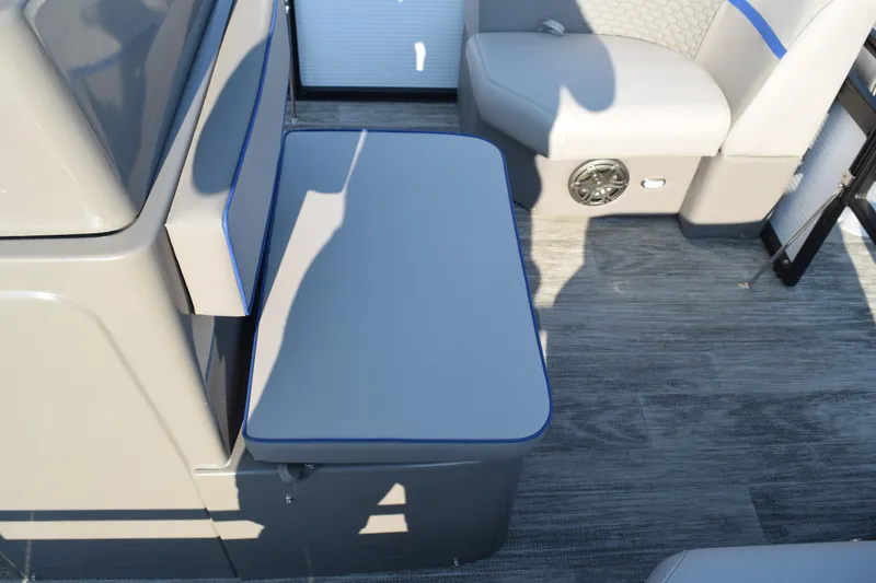 Slide: The Image of 2025 Angler Qwest 8524 ALL SPORT boat interior with gray seating and flooring. - 24