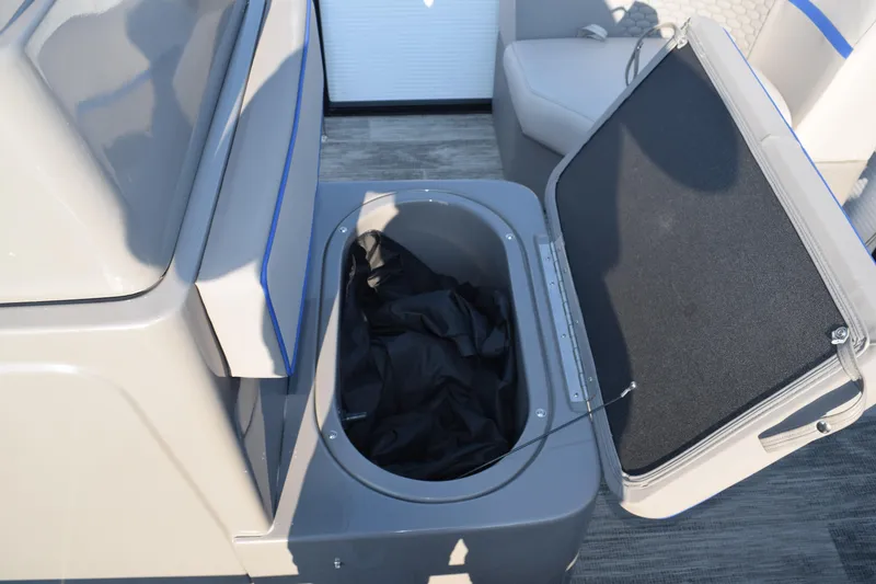 Slide: The Image of 2025 Angler Qwest 8524 ALL SPORT storage compartment with open lid, showcasing interior space. - 25