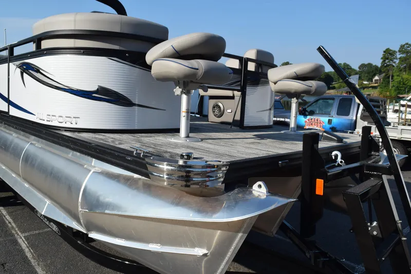 Slide: The Image of 2025 Angler Qwest 8524 ALL SPORT pontoon boat with seating, docked at marina. - 28