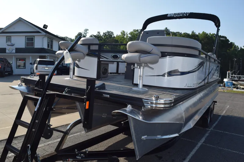 Slide: The Image of 2025 Angler Qwest 8524 ALL SPORT pontoon boat on trailer in parking lot. - 3