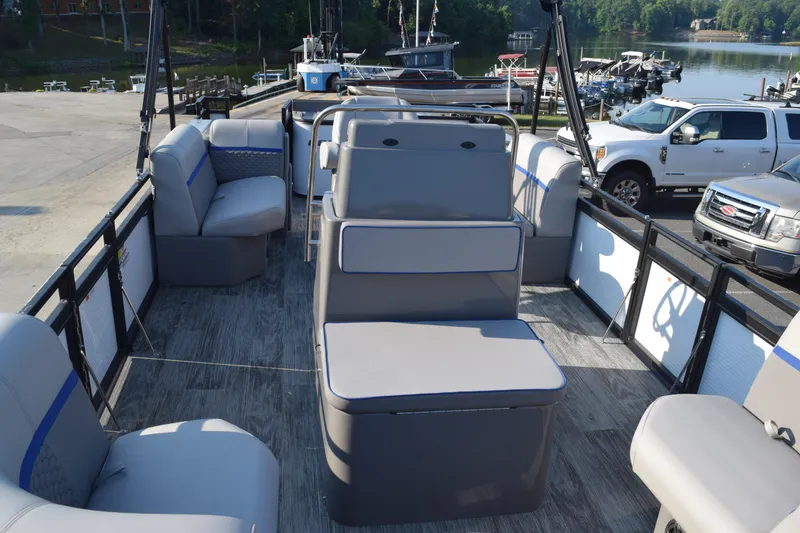 Slide: The Image of 2025 Angler Qwest 8524 ALL SPORT pontoon boat interior with seating and lake view. - 9