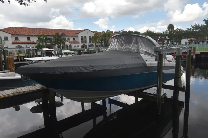 Slide: The Image of 2018 Pronautica 34 boat docked with cover, in a marina setting. - 1