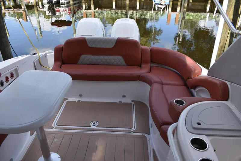 Slide: The Image of 2018 Pronautica 34 boat interior with red seating and table, docked by the water. - 10