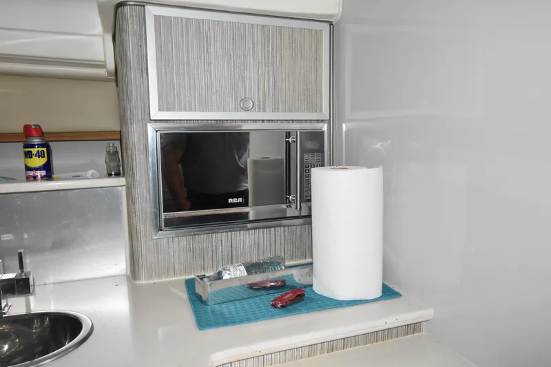 Slide: The Image of 2018 Pronautica 34 interior kitchen with microwave, sink, and paper towel. - 13