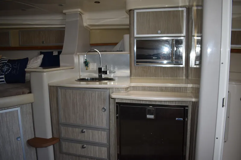 Slide: The Image of 2018 Pronautica 34 yacht interior with kitchenette, sink, and storage cabinets. - 23